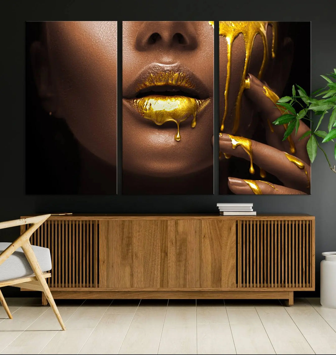 A triptych art display of the African American Art Black Woman Canvas Print, featuring gold-painted lips inspired by fashion and luxury, is elegantly arranged.