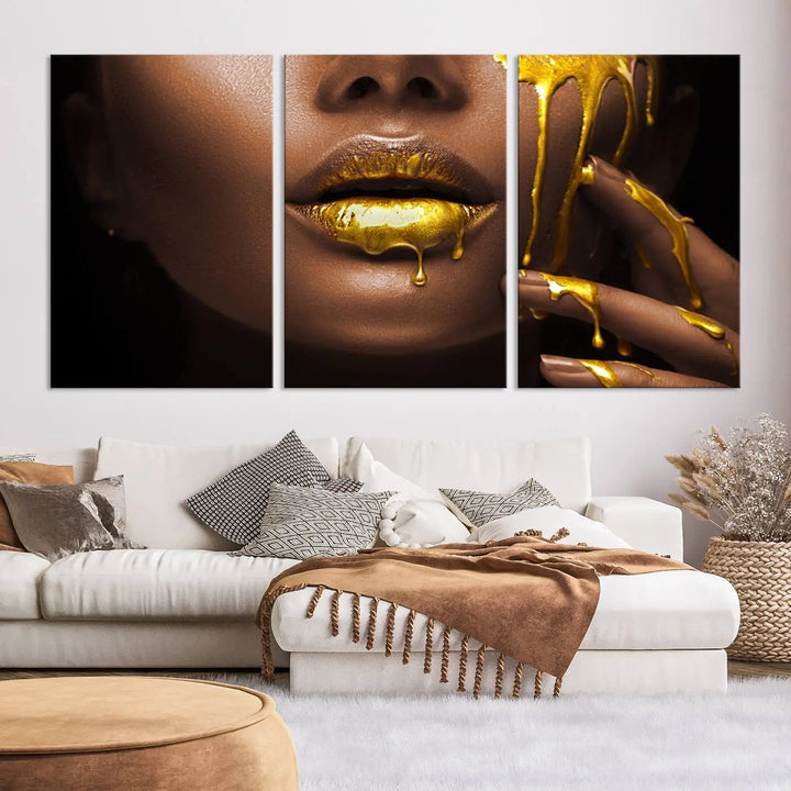 A triptych art display of the African American Art Black Woman Canvas Print, featuring gold-painted lips inspired by fashion and luxury, is elegantly arranged.