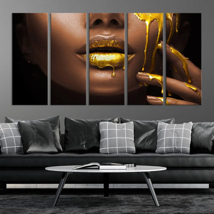 A triptych art display of the African American Art Black Woman Canvas Print, featuring gold-painted lips inspired by fashion and luxury, is elegantly arranged.