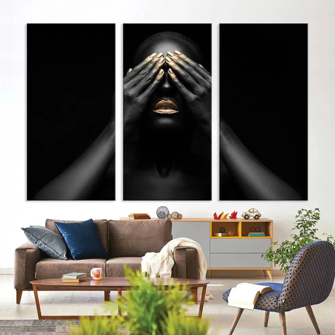 The African American Art Black and White Canvas Wall Art Gold Lips Art is a striking triptych featuring a woman with gold lips and nails covering her eyes.