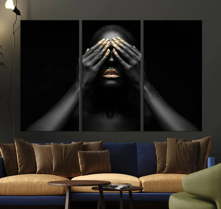 The African American Art Black and White Canvas Wall Art Gold Lips Art is a striking triptych featuring a woman with gold lips and nails covering her eyes.