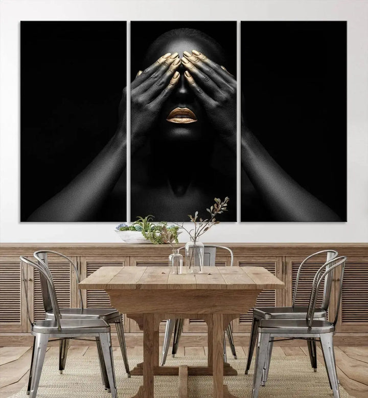 The African American Art Black and White Canvas Wall Art Gold Lips Art is a striking triptych featuring a woman with gold lips and nails covering her eyes.