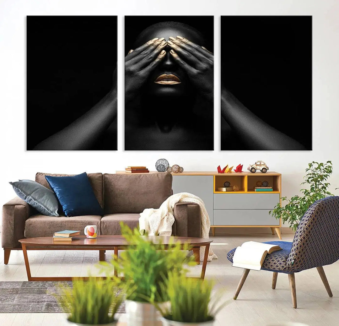 The African American Art Black and White Canvas Wall Art Gold Lips Art is a striking triptych featuring a woman with gold lips and nails covering her eyes.