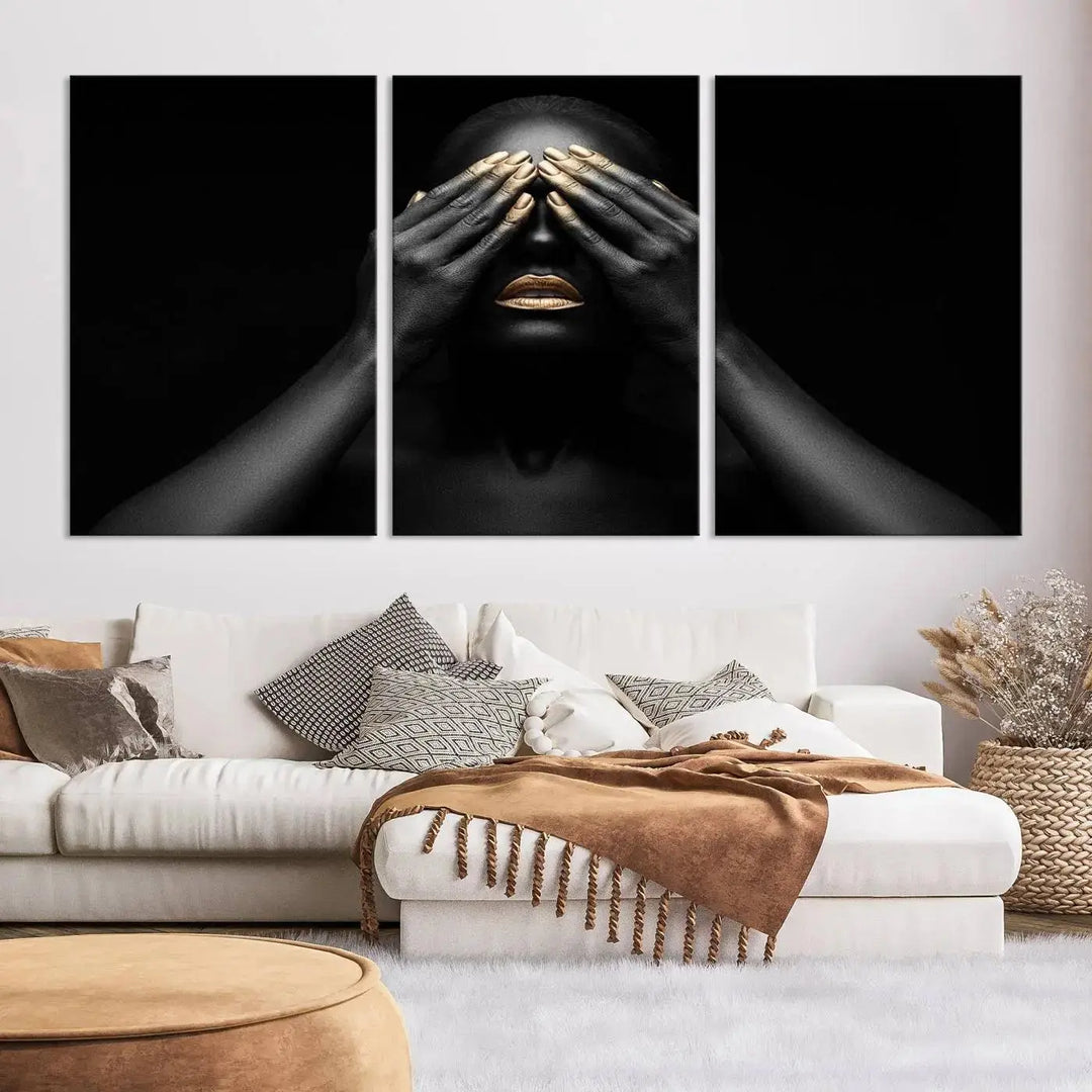 The African American Art Black and White Canvas Wall Art Gold Lips Art is a striking triptych featuring a woman with gold lips and nails covering her eyes.