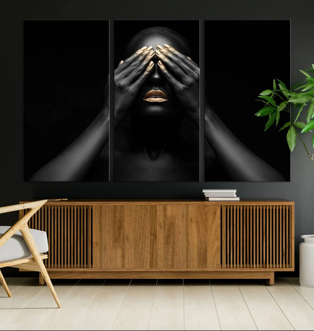 The African American Art Black and White Canvas Wall Art Gold Lips Art is a striking triptych featuring a woman with gold lips and nails covering her eyes.