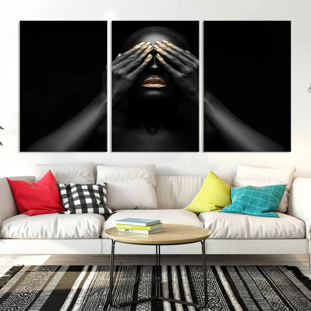 The African American Art Black and White Canvas Wall Art Gold Lips Art is a striking triptych featuring a woman with gold lips and nails covering her eyes.