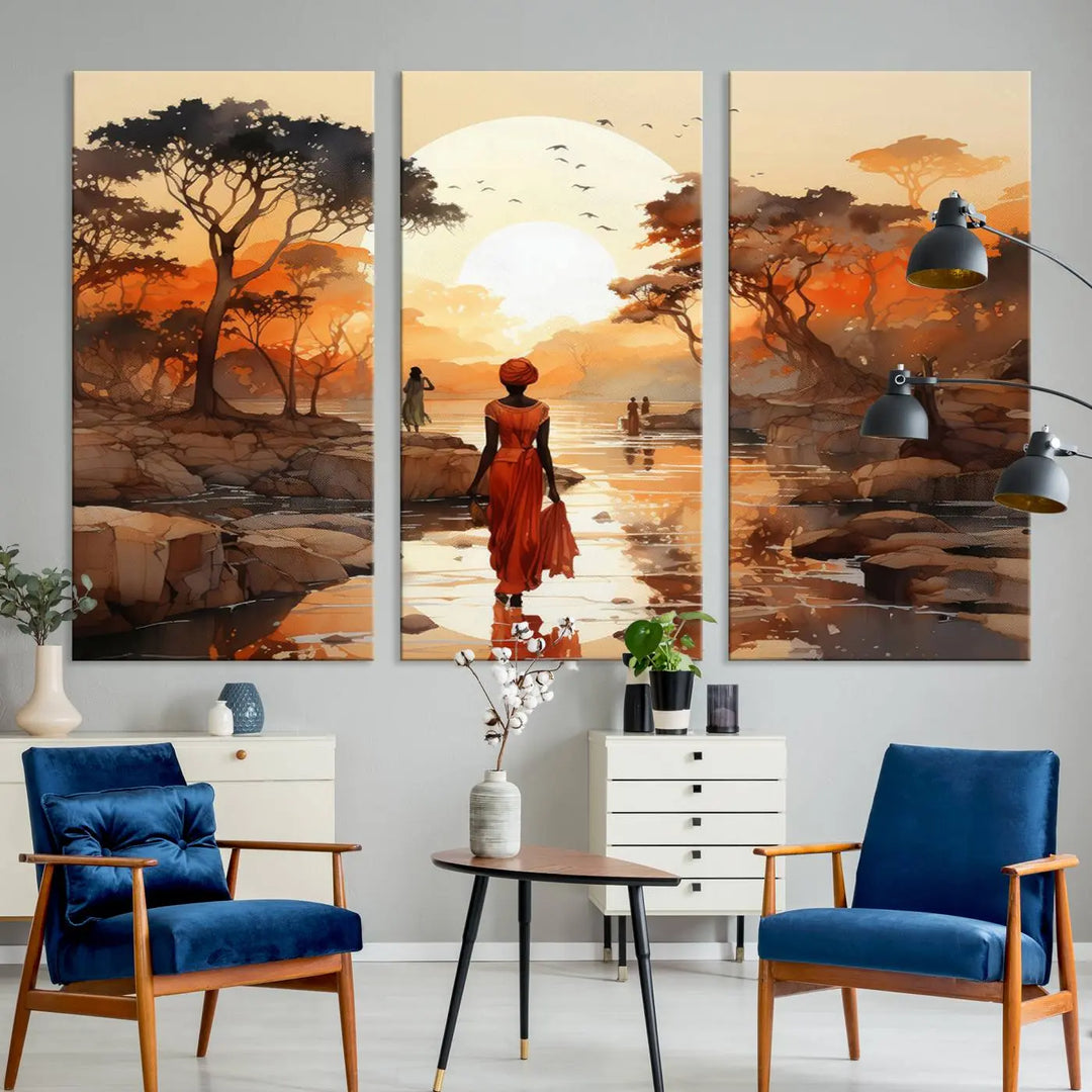 The African Journey Wall Art Canvas Print showcases an African woman in red walking towards a sunset on a scenic path. This museum-quality canvas split art is enhanced with high-resolution printing and UV-protective coating, creating an elegant display.