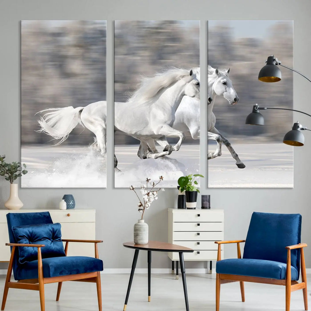 The "All The White Horses Wall Art Canvas Print" depicts a triptych of galloping white horses across a snowy landscape. These museum-quality canvases come with a UV-protective coating to maintain their stunning appearance over time.