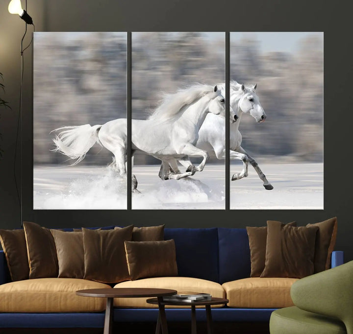 The "All The White Horses Wall Art Canvas Print" depicts a triptych of galloping white horses across a snowy landscape. These museum-quality canvases come with a UV-protective coating to maintain their stunning appearance over time.