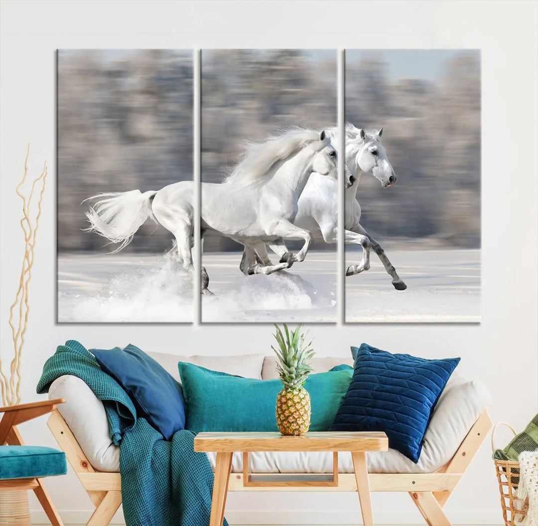 The "All The White Horses Wall Art Canvas Print" depicts a triptych of galloping white horses across a snowy landscape. These museum-quality canvases come with a UV-protective coating to maintain their stunning appearance over time.