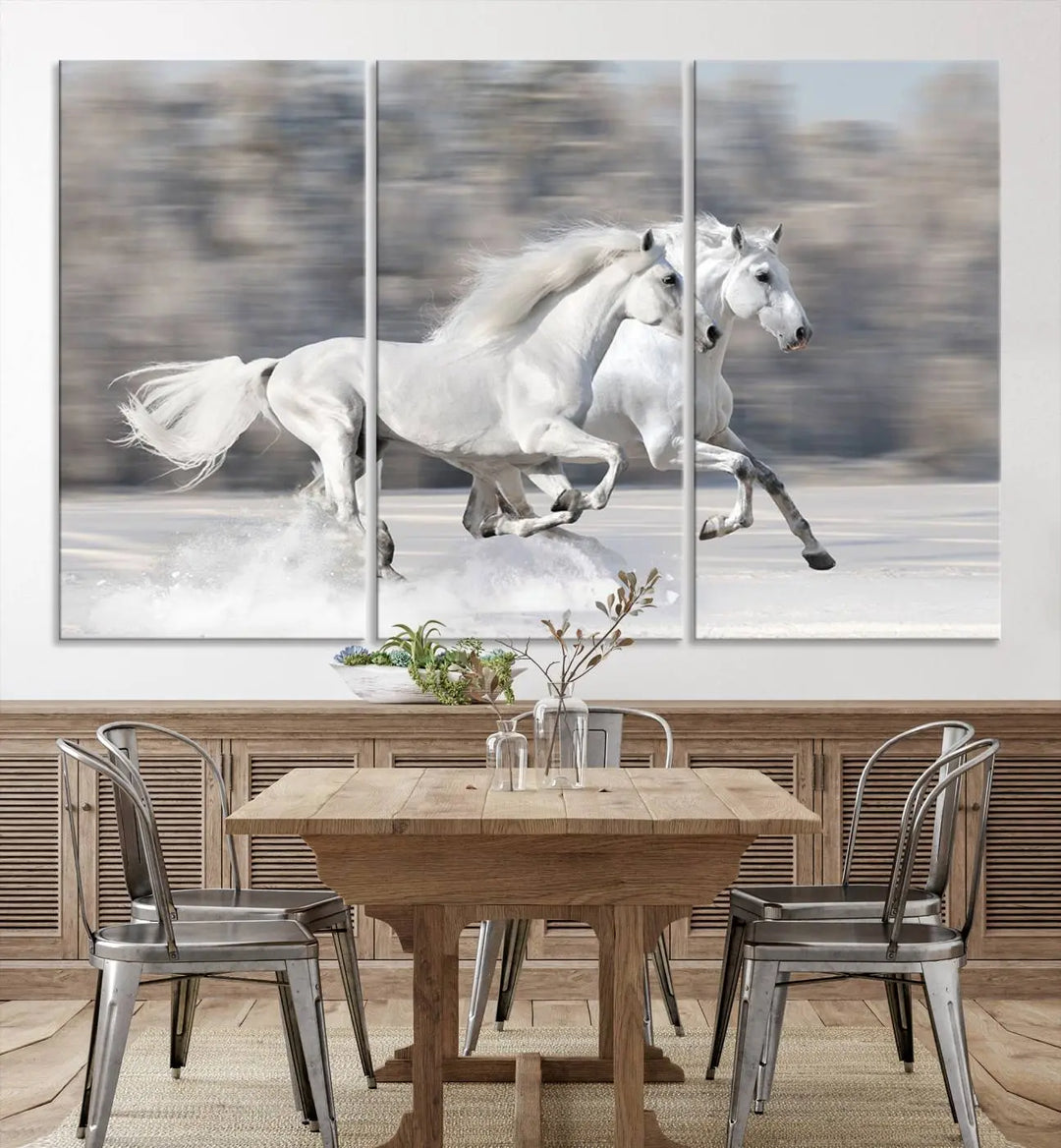 The "All The White Horses Wall Art Canvas Print" depicts a triptych of galloping white horses across a snowy landscape. These museum-quality canvases come with a UV-protective coating to maintain their stunning appearance over time.