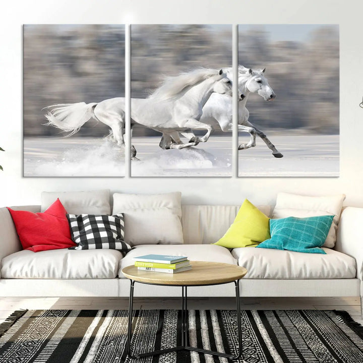 The "All The White Horses Wall Art Canvas Print" depicts a triptych of galloping white horses across a snowy landscape. These museum-quality canvases come with a UV-protective coating to maintain their stunning appearance over time.