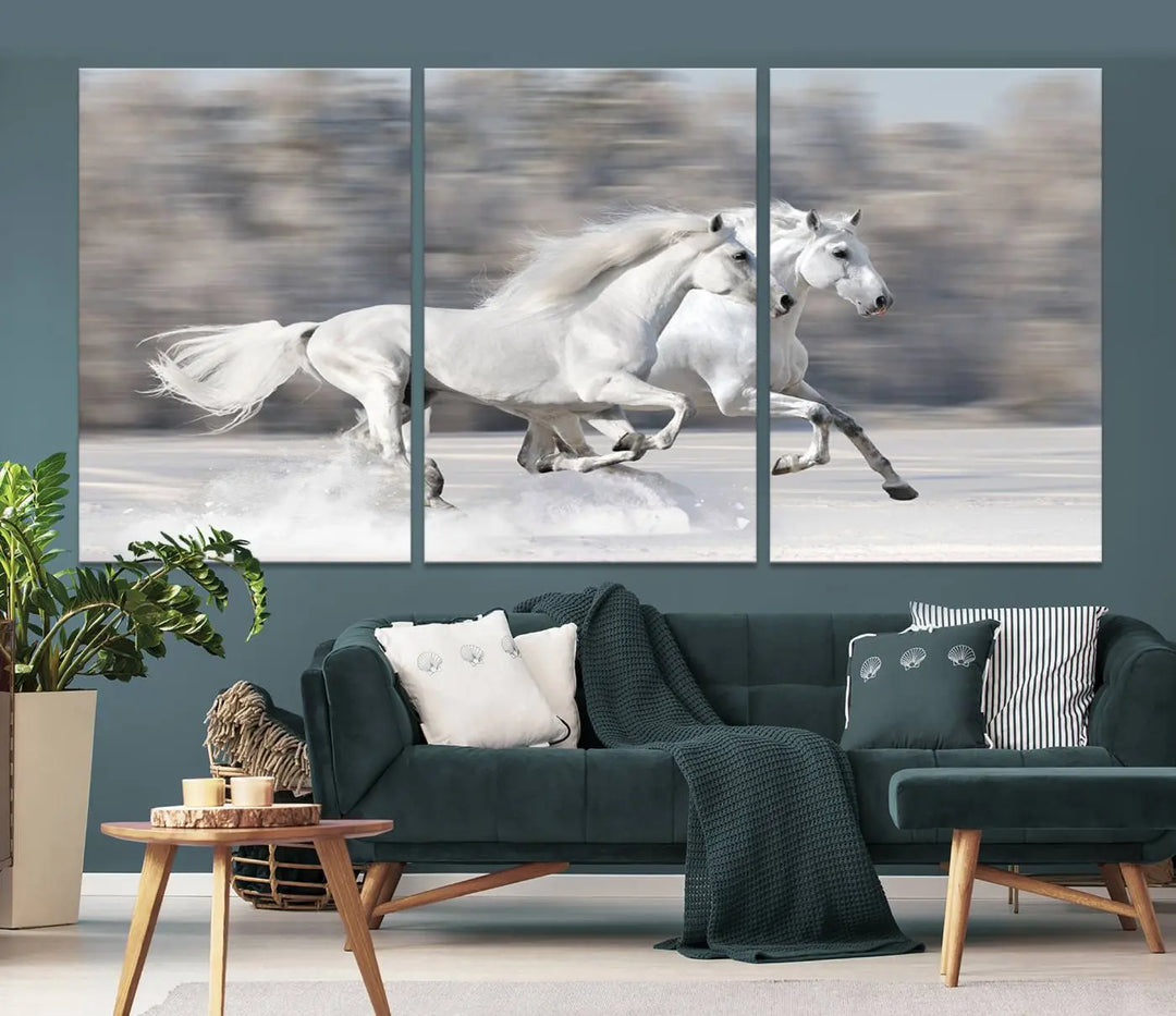 The "All The White Horses Wall Art Canvas Print" depicts a triptych of galloping white horses across a snowy landscape. These museum-quality canvases come with a UV-protective coating to maintain their stunning appearance over time.