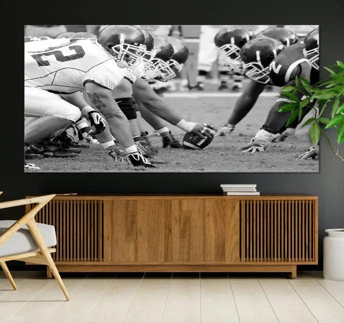 The "American Football Player Wall Art Canvas Print," beautifully rendered in black and white, captures a football scrimmage line and is printed on museum-quality canvas. This artwork is divided into three stunning panels and comes ready to hang for easy integration into your space.