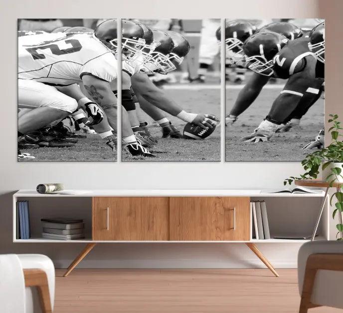 The "American Football Player Wall Art Canvas Print," beautifully rendered in black and white, captures a football scrimmage line and is printed on museum-quality canvas. This artwork is divided into three stunning panels and comes ready to hang for easy integration into your space.