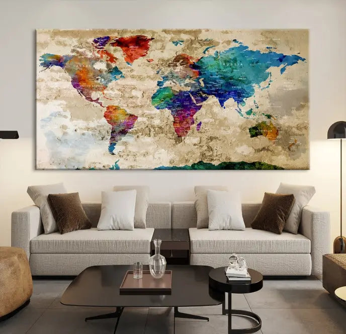 The contemporary living room showcases the "Watercolor Wall Art Push Pin World Map w/ Antarctica Canvas Print" on the wall. This museum-quality canvas is equipped with a UV-protective coating, guaranteeing vibrant colors endure for years, and it's ready to hang for an immediate style enhancement.