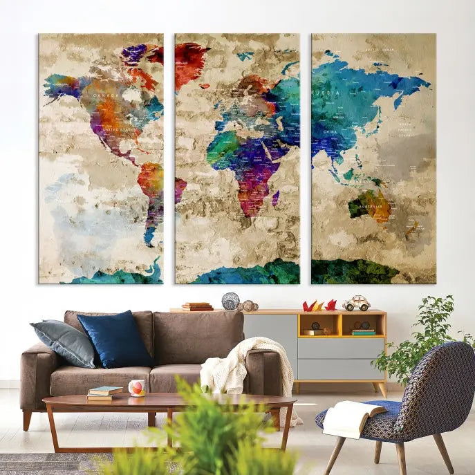 The contemporary living room showcases the "Watercolor Wall Art Push Pin World Map w/ Antarctica Canvas Print" on the wall. This museum-quality canvas is equipped with a UV-protective coating, guaranteeing vibrant colors endure for years, and it's ready to hang for an immediate style enhancement.