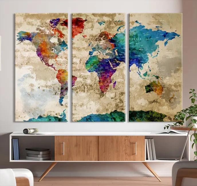 The contemporary living room showcases the "Watercolor Wall Art Push Pin World Map w/ Antarctica Canvas Print" on the wall. This museum-quality canvas is equipped with a UV-protective coating, guaranteeing vibrant colors endure for years, and it's ready to hang for an immediate style enhancement.