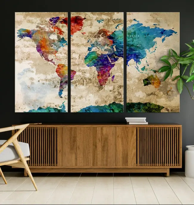 The contemporary living room showcases the "Watercolor Wall Art Push Pin World Map w/ Antarctica Canvas Print" on the wall. This museum-quality canvas is equipped with a UV-protective coating, guaranteeing vibrant colors endure for years, and it's ready to hang for an immediate style enhancement.