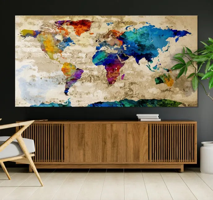 A three-panel "Watercolor Wall Art World Map w/ Antarctica Canvas Print" on museum-quality canvas features vibrant colors and is ready to hang in a dimly lit living room.