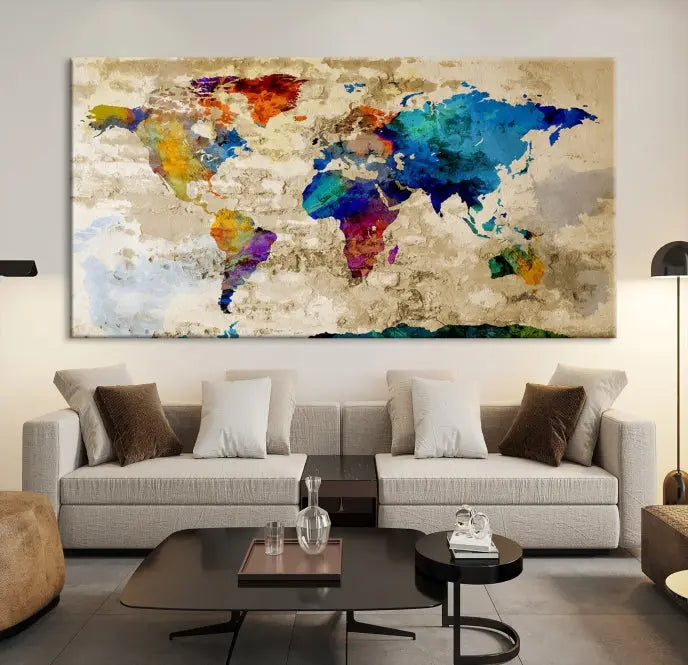 A three-panel "Watercolor Wall Art World Map w/ Antarctica Canvas Print" on museum-quality canvas features vibrant colors and is ready to hang in a dimly lit living room.