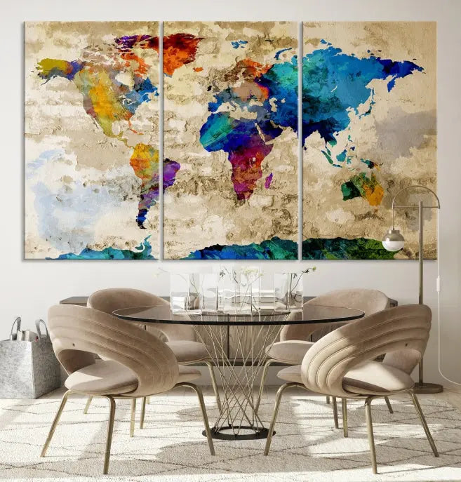 A three-panel "Watercolor Wall Art World Map w/ Antarctica Canvas Print" on museum-quality canvas features vibrant colors and is ready to hang in a dimly lit living room.