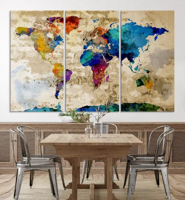 A three-panel "Watercolor Wall Art World Map w/ Antarctica Canvas Print" on museum-quality canvas features vibrant colors and is ready to hang in a dimly lit living room.