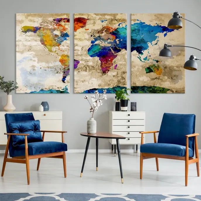 A three-panel "Watercolor Wall Art World Map w/ Antarctica Canvas Print" on museum-quality canvas features vibrant colors and is ready to hang in a dimly lit living room.