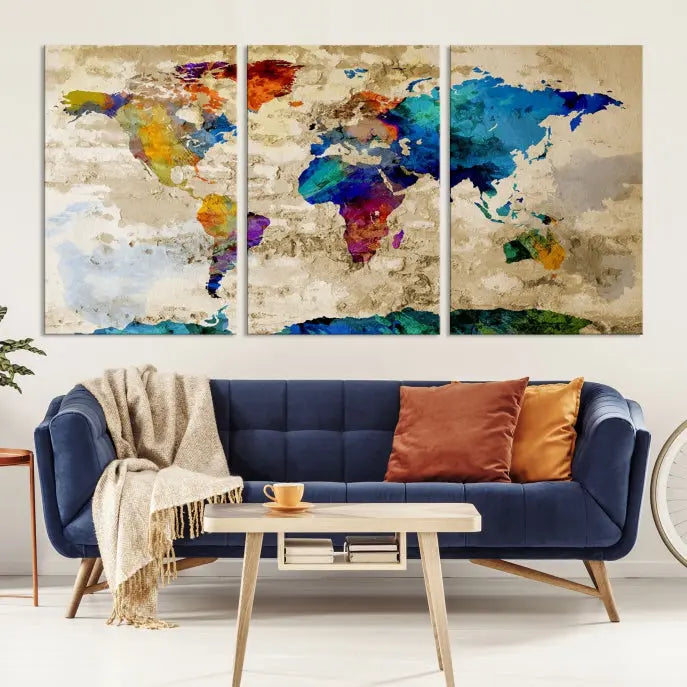 A three-panel "Watercolor Wall Art World Map w/ Antarctica Canvas Print" on museum-quality canvas features vibrant colors and is ready to hang in a dimly lit living room.