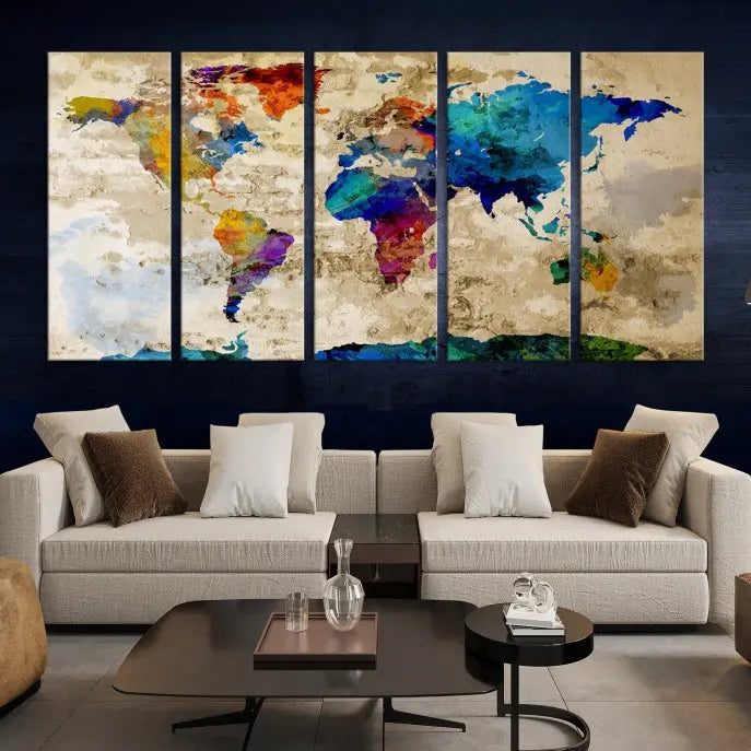 A three-panel "Watercolor Wall Art World Map w/ Antarctica Canvas Print" on museum-quality canvas features vibrant colors and is ready to hang in a dimly lit living room.