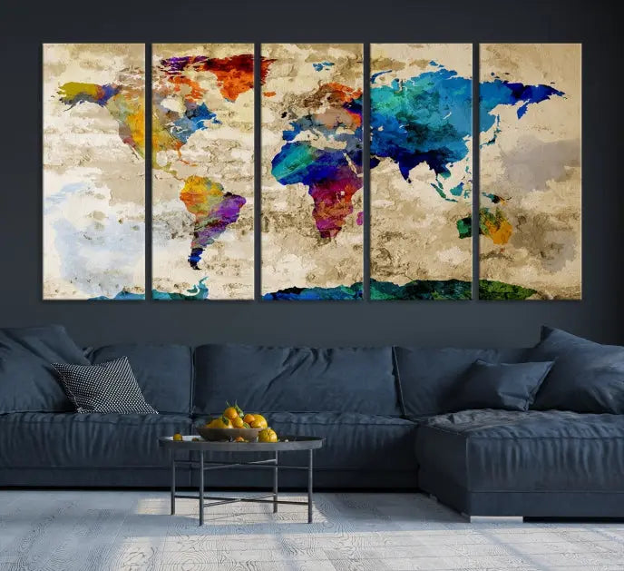 A three-panel "Watercolor Wall Art World Map w/ Antarctica Canvas Print" on museum-quality canvas features vibrant colors and is ready to hang in a dimly lit living room.