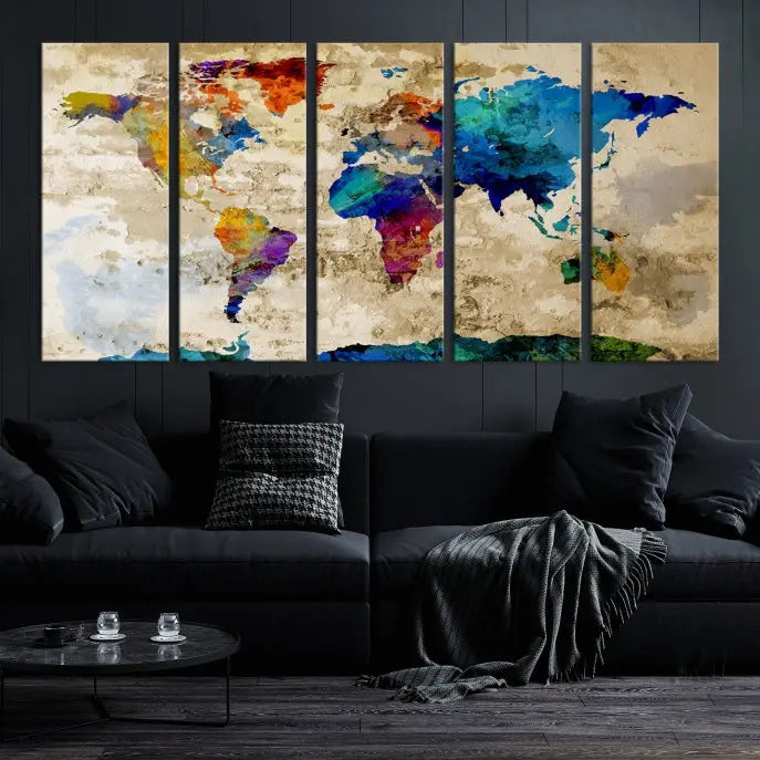 A three-panel "Watercolor Wall Art World Map w/ Antarctica Canvas Print" on museum-quality canvas features vibrant colors and is ready to hang in a dimly lit living room.