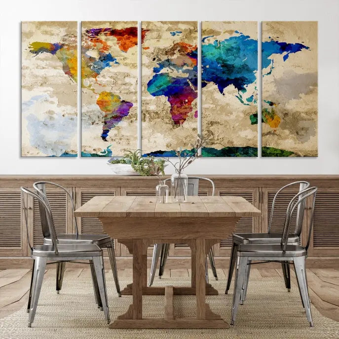 A three-panel "Watercolor Wall Art World Map w/ Antarctica Canvas Print" on museum-quality canvas features vibrant colors and is ready to hang in a dimly lit living room.