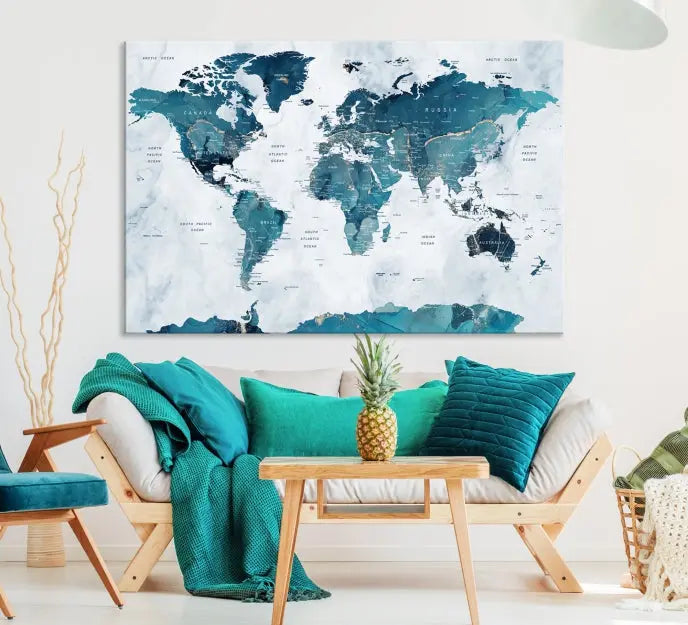 A Push Pin World Map with Antarctica, printed on museum-quality canvas portraying blue oceans, is displayed as a triptych above a dark wall.