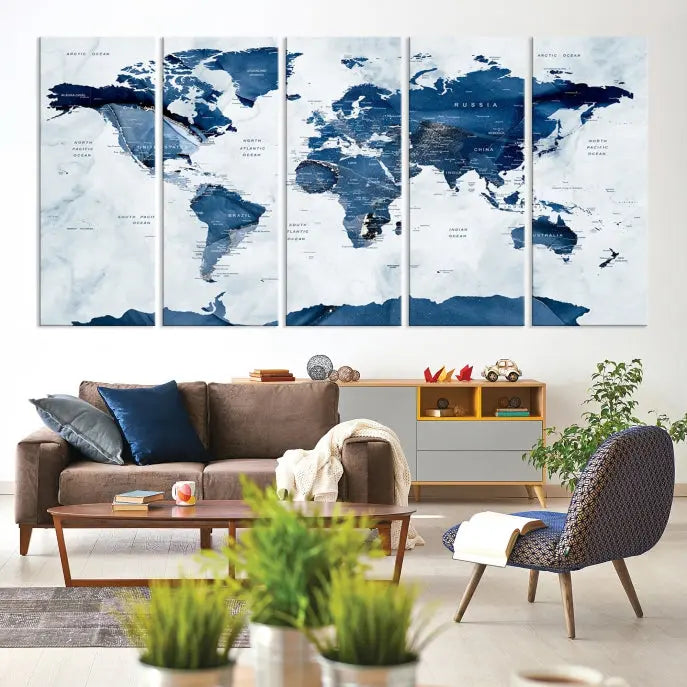 The Navy Blue World Map with Antarctica Wall Art Canvas Print, featuring a stunning blend of blue and white on a museum-quality canvas, elegantly adorns a dark wall. This ready-to-hang masterpiece enhances the room's sophisticated ambiance.