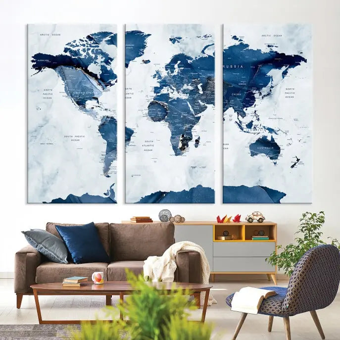 The Navy Blue World Map with Antarctica Wall Art Canvas Print, featuring a stunning blend of blue and white on a museum-quality canvas, elegantly adorns a dark wall. This ready-to-hang masterpiece enhances the room's sophisticated ambiance.