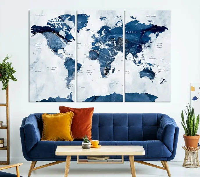 The Navy Blue World Map with Antarctica Wall Art Canvas Print, featuring a stunning blend of blue and white on a museum-quality canvas, elegantly adorns a dark wall. This ready-to-hang masterpiece enhances the room's sophisticated ambiance.