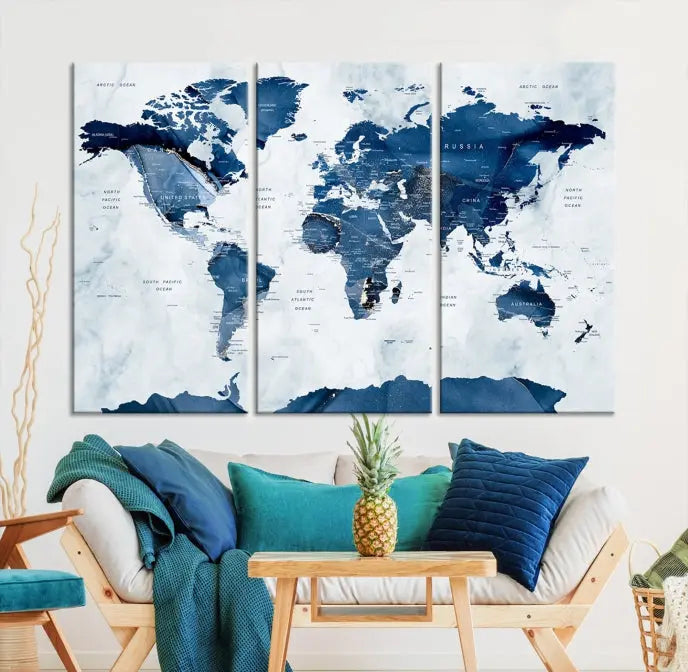 The Navy Blue World Map with Antarctica Wall Art Canvas Print, featuring a stunning blend of blue and white on a museum-quality canvas, elegantly adorns a dark wall. This ready-to-hang masterpiece enhances the room's sophisticated ambiance.