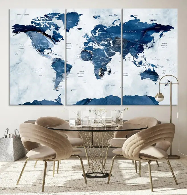 The Navy Blue World Map with Antarctica Wall Art Canvas Print, featuring a stunning blend of blue and white on a museum-quality canvas, elegantly adorns a dark wall. This ready-to-hang masterpiece enhances the room's sophisticated ambiance.