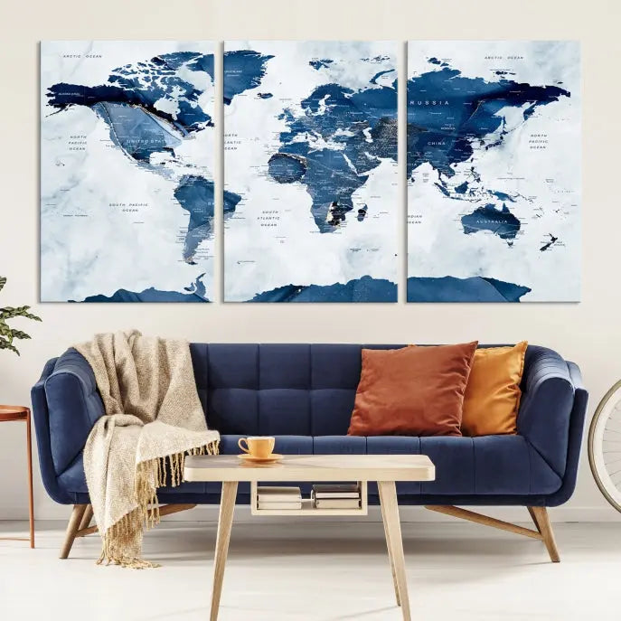 The Navy Blue World Map with Antarctica Wall Art Canvas Print, featuring a stunning blend of blue and white on a museum-quality canvas, elegantly adorns a dark wall. This ready-to-hang masterpiece enhances the room's sophisticated ambiance.