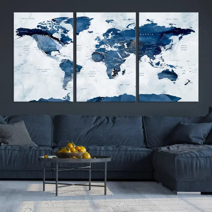 The Navy Blue World Map with Antarctica Wall Art Canvas Print, featuring a stunning blend of blue and white on a museum-quality canvas, elegantly adorns a dark wall. This ready-to-hang masterpiece enhances the room's sophisticated ambiance.