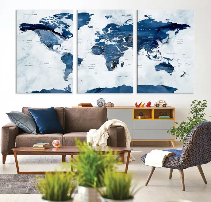 The Navy Blue World Map with Antarctica Wall Art Canvas Print, featuring a stunning blend of blue and white on a museum-quality canvas, elegantly adorns a dark wall. This ready-to-hang masterpiece enhances the room's sophisticated ambiance.