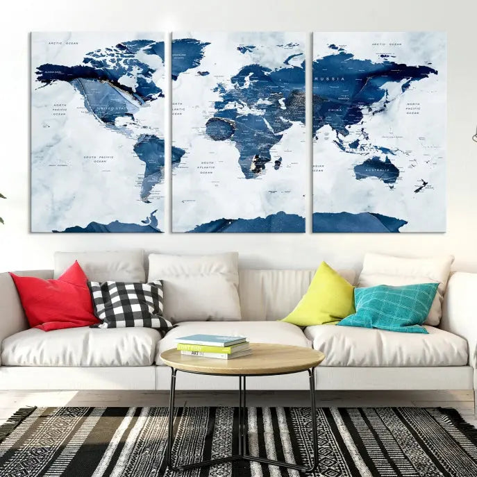 The Navy Blue World Map with Antarctica Wall Art Canvas Print, featuring a stunning blend of blue and white on a museum-quality canvas, elegantly adorns a dark wall. This ready-to-hang masterpiece enhances the room's sophisticated ambiance.