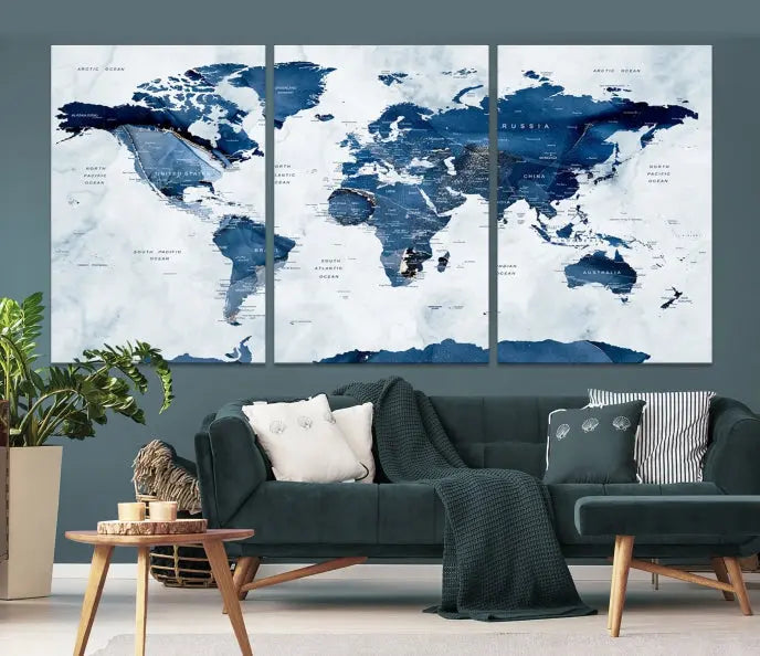 The Navy Blue World Map with Antarctica Wall Art Canvas Print, featuring a stunning blend of blue and white on a museum-quality canvas, elegantly adorns a dark wall. This ready-to-hang masterpiece enhances the room's sophisticated ambiance.