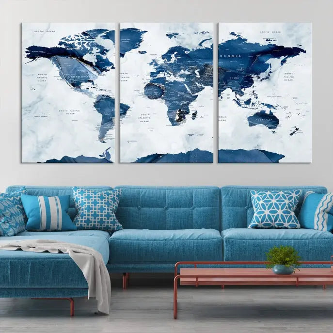 The Navy Blue World Map with Antarctica Wall Art Canvas Print, featuring a stunning blend of blue and white on a museum-quality canvas, elegantly adorns a dark wall. This ready-to-hang masterpiece enhances the room's sophisticated ambiance.