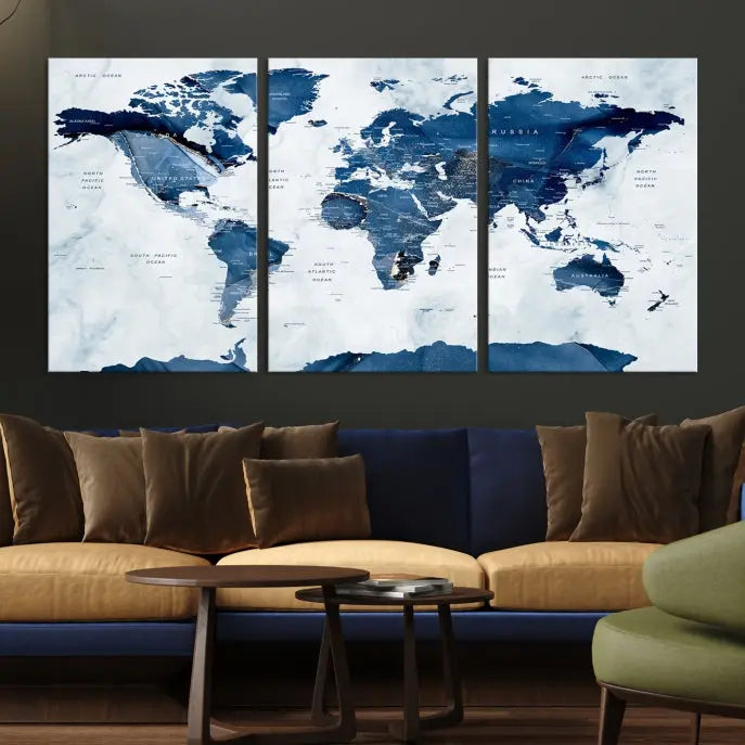 The Navy Blue World Map with Antarctica Wall Art Canvas Print, featuring a stunning blend of blue and white on a museum-quality canvas, elegantly adorns a dark wall. This ready-to-hang masterpiece enhances the room's sophisticated ambiance.