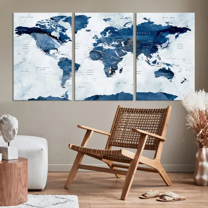 The Navy Blue World Map with Antarctica Wall Art Canvas Print, featuring a stunning blend of blue and white on a museum-quality canvas, elegantly adorns a dark wall. This ready-to-hang masterpiece enhances the room's sophisticated ambiance.