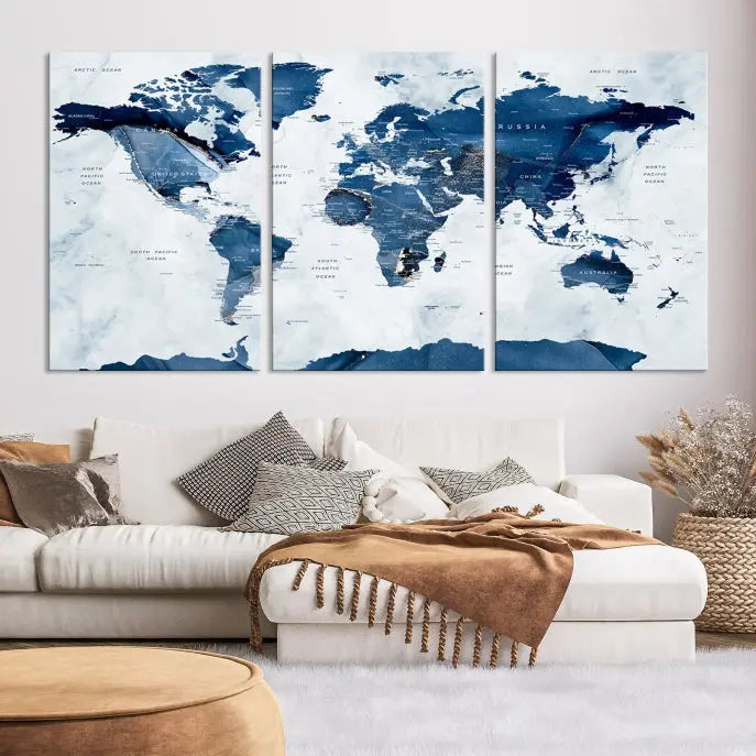 The Navy Blue World Map with Antarctica Wall Art Canvas Print, featuring a stunning blend of blue and white on a museum-quality canvas, elegantly adorns a dark wall. This ready-to-hang masterpiece enhances the room's sophisticated ambiance.