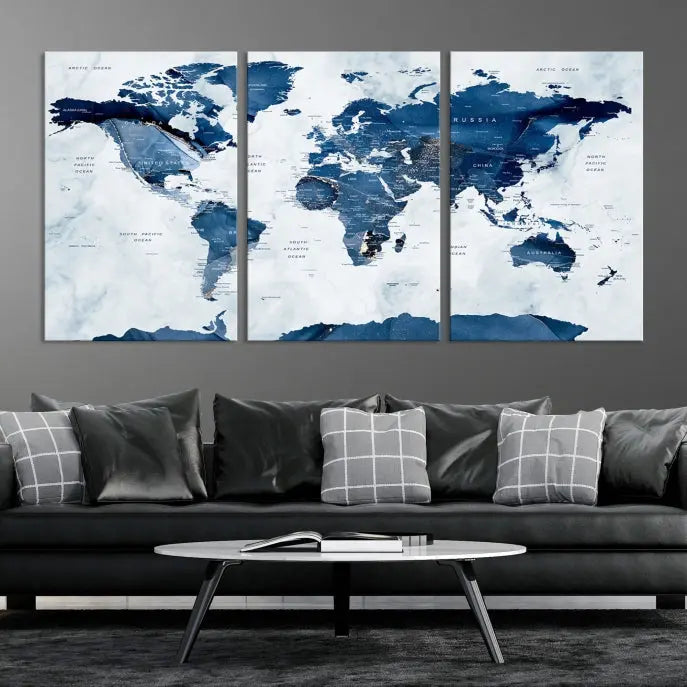 The Navy Blue World Map with Antarctica Wall Art Canvas Print, featuring a stunning blend of blue and white on a museum-quality canvas, elegantly adorns a dark wall. This ready-to-hang masterpiece enhances the room's sophisticated ambiance.