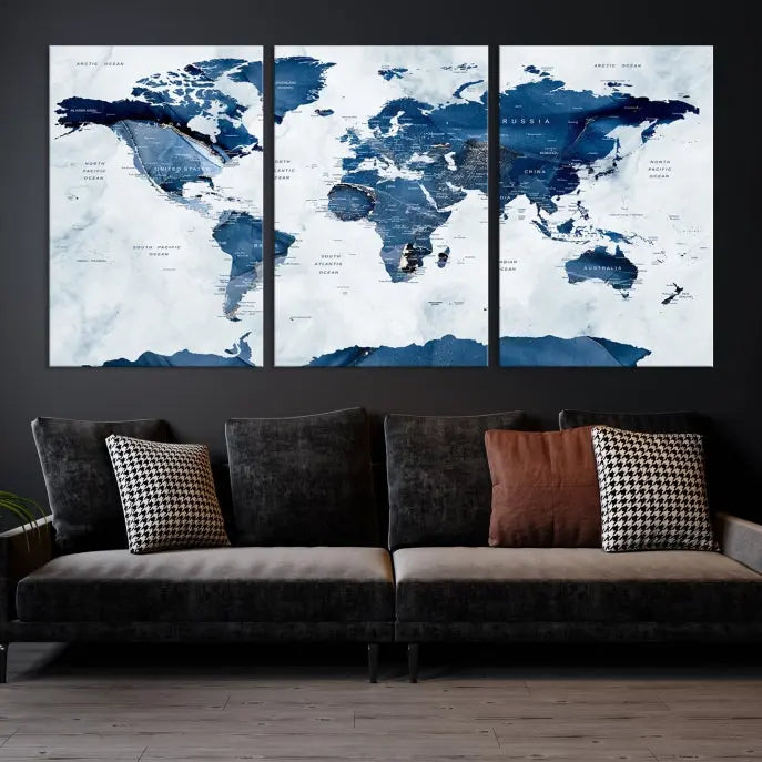 The Navy Blue World Map with Antarctica Wall Art Canvas Print, featuring a stunning blend of blue and white on a museum-quality canvas, elegantly adorns a dark wall. This ready-to-hang masterpiece enhances the room's sophisticated ambiance.